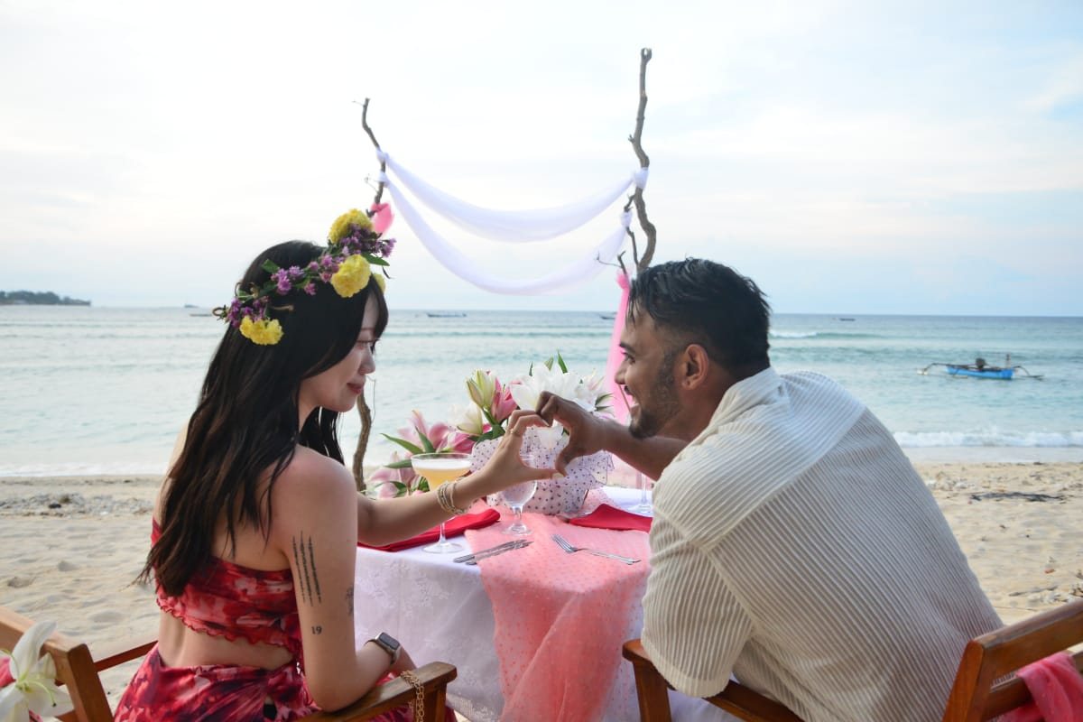 Romantic dinner setup on the beach with flowers